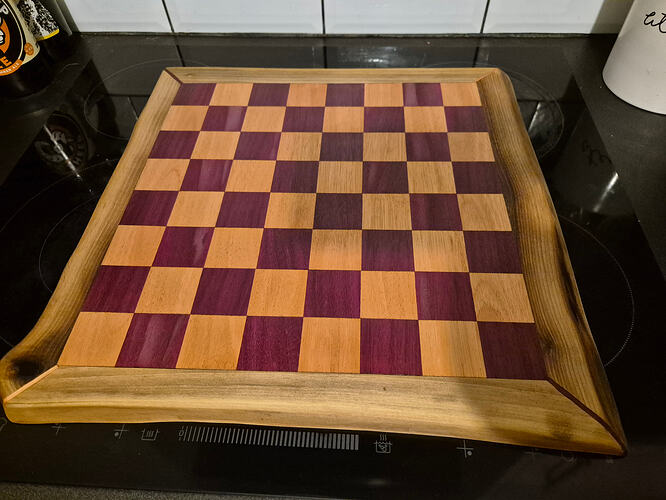 Chessboard made using Adrian rosewood, purple heart and walnut live edge.